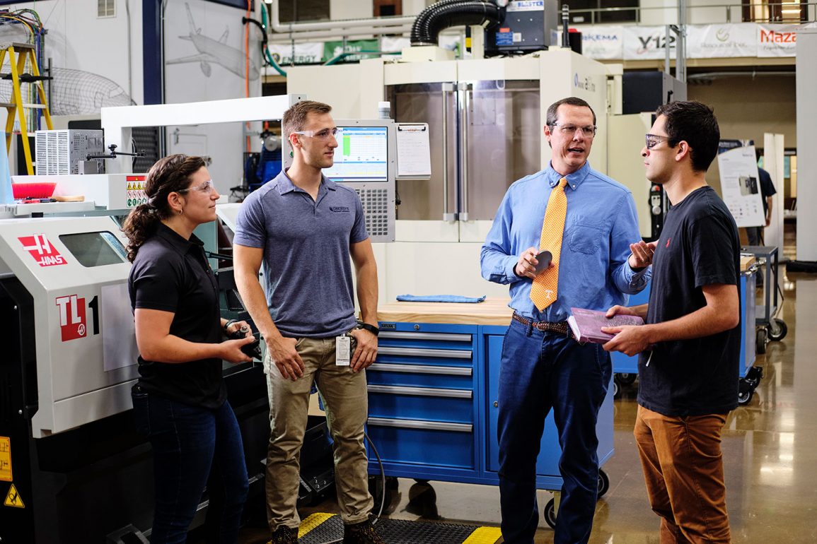 Tony Schmitz works with grad students on ORNL research project
