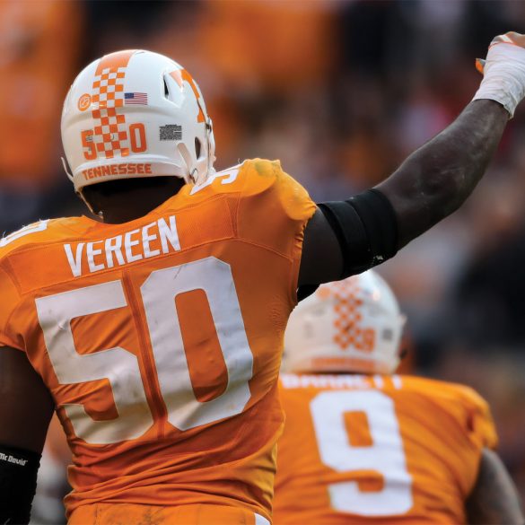 Corey Vereen raises his hand to fans at football game
