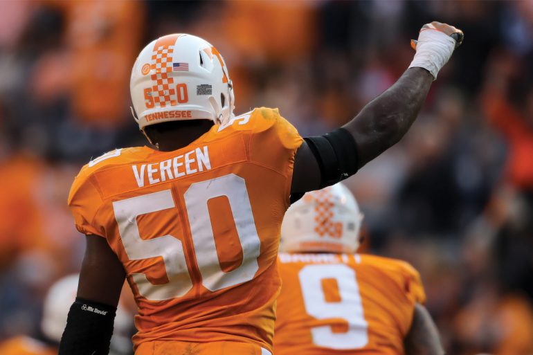 Corey Vereen raises his hand to fans at football game