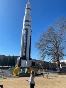 Katie Davis posing in front of rocket