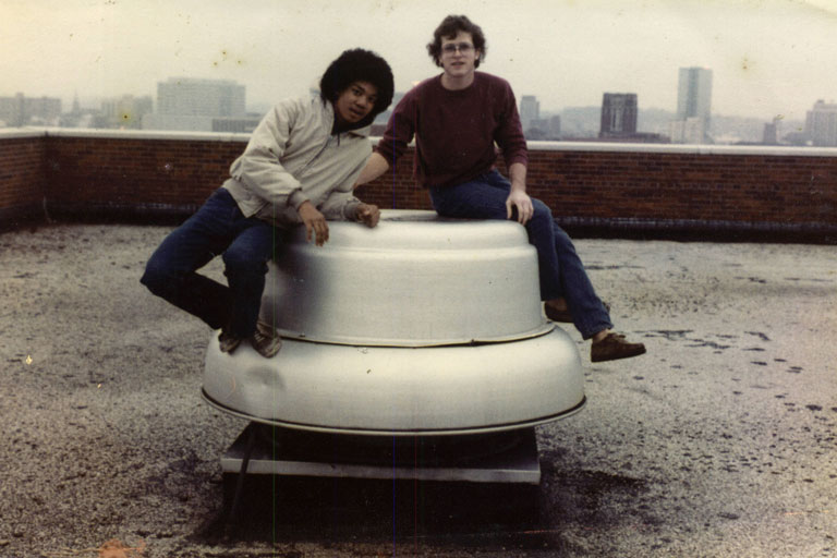 Dwight Hutchins sitting on rooftop with other student