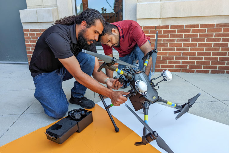 Khalid Alshibli and Amirsalar “Saul” Moslehy looking at the drone