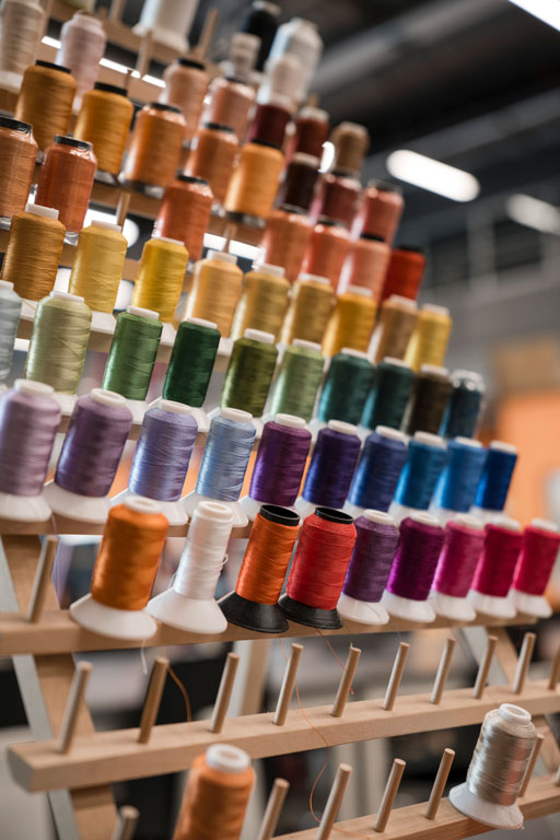 spools of thread supply the Brother embroidering machine 