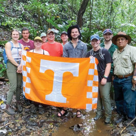 Students posing for picture with University of Tennessee flag in Panama