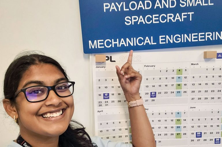 Sreya Kumpatia pointing to a chart with the heading "Payload and Small Spacecraft"