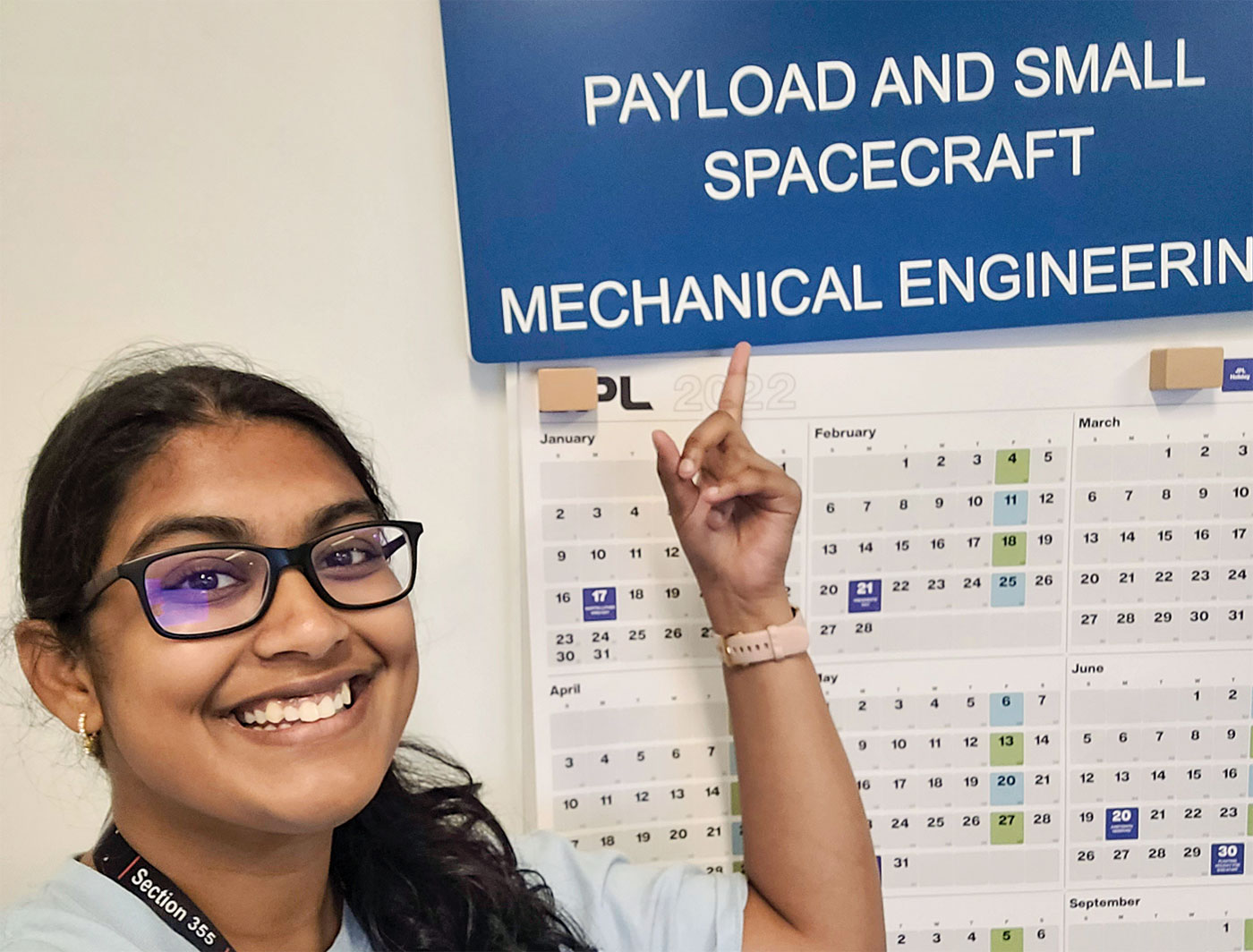 Sreya Kumpatia pointing to a chart with the heading "Payload and Small Spacecraft"