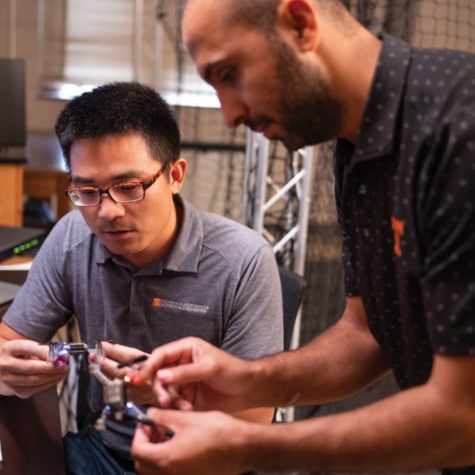 Assistant Professor Zhenbo Wang working with a drone