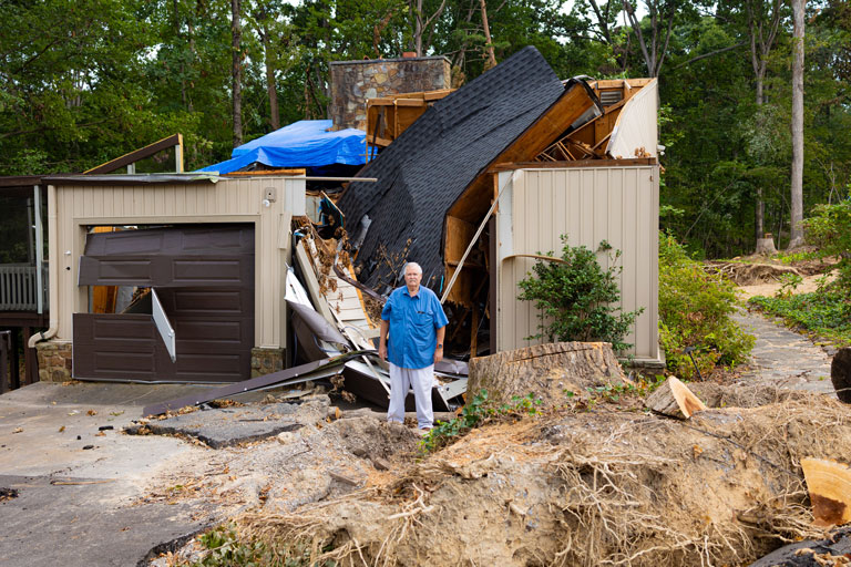 Terry Hazen standing outside in the middle of the damage caused by the tornado.