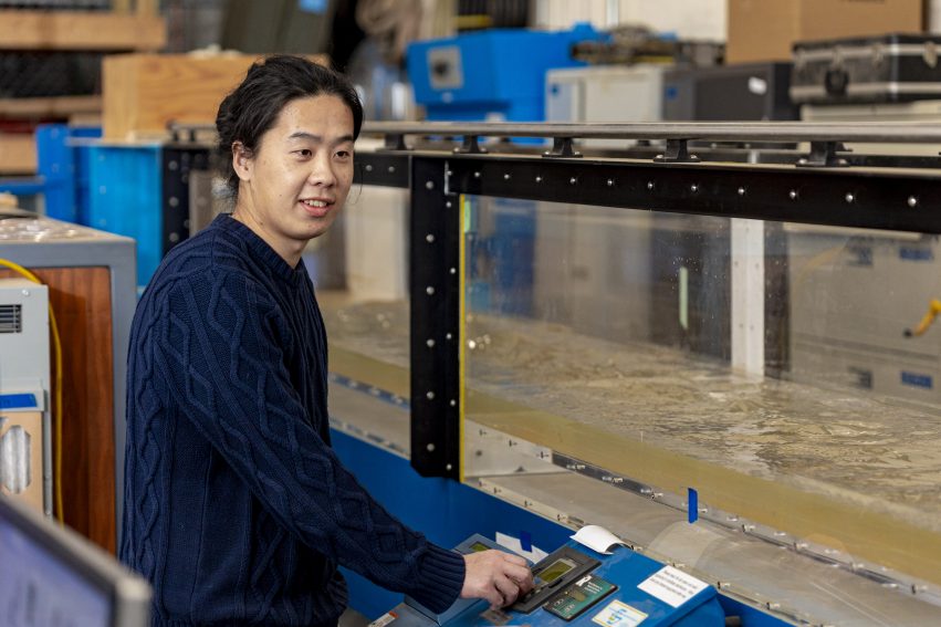 Haochen Li standing next to a water turbidity machine