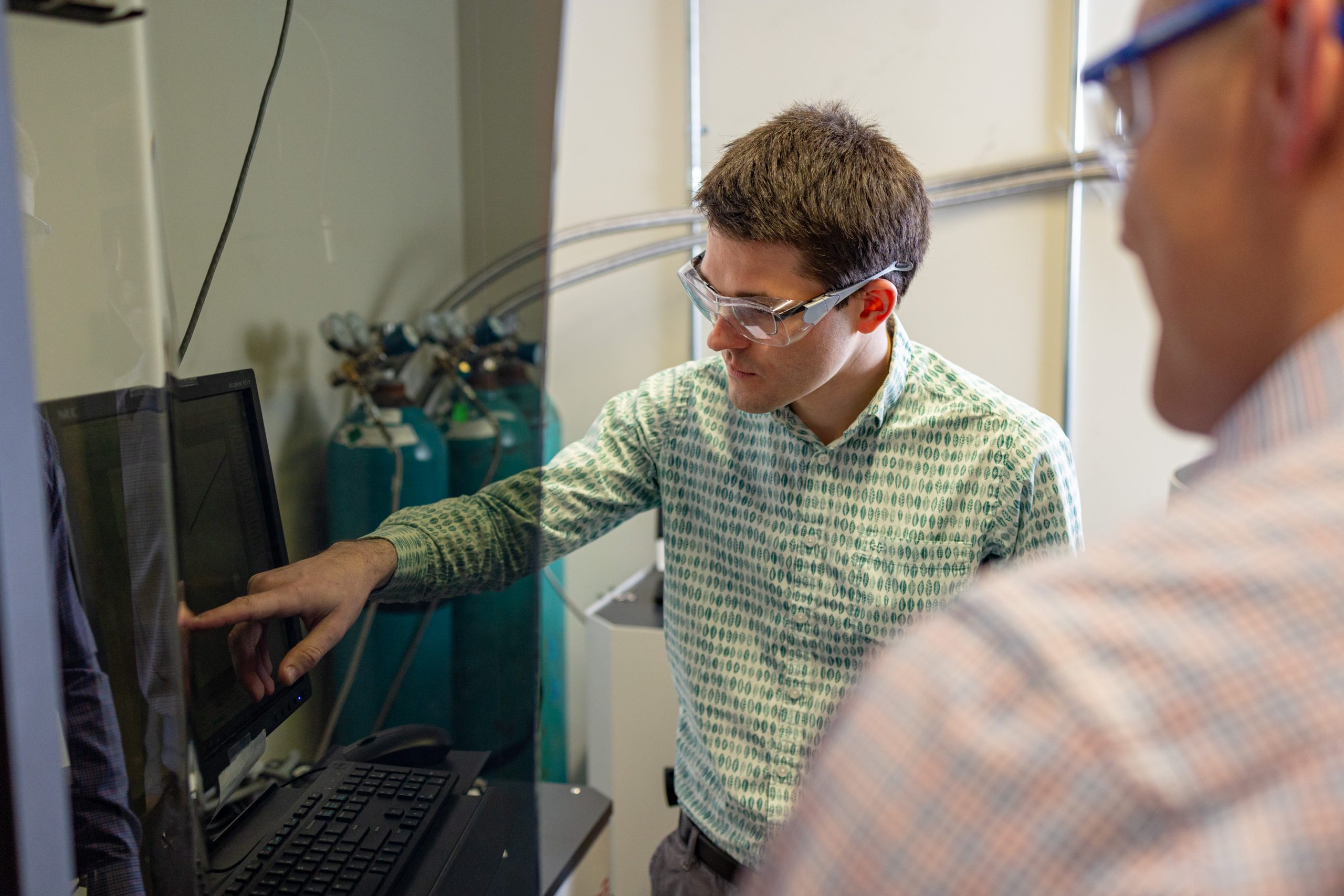 William Meier explaining data to a colleague in a lab