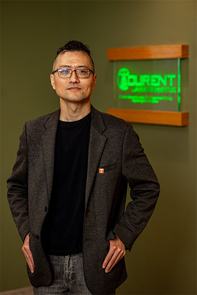 Kevin Bai in front of CURENT sign.