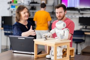 Lynne Parker working with a student on a robot