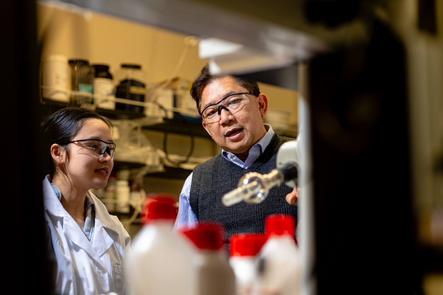 Rigoberto Advincula and his student working on a project in a lab