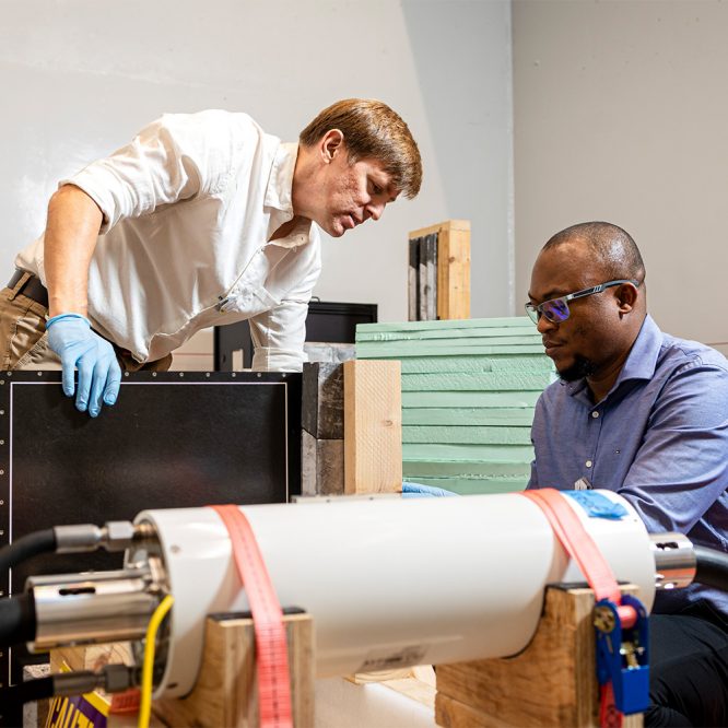 Jason Hayward working with a professor on their consortium project