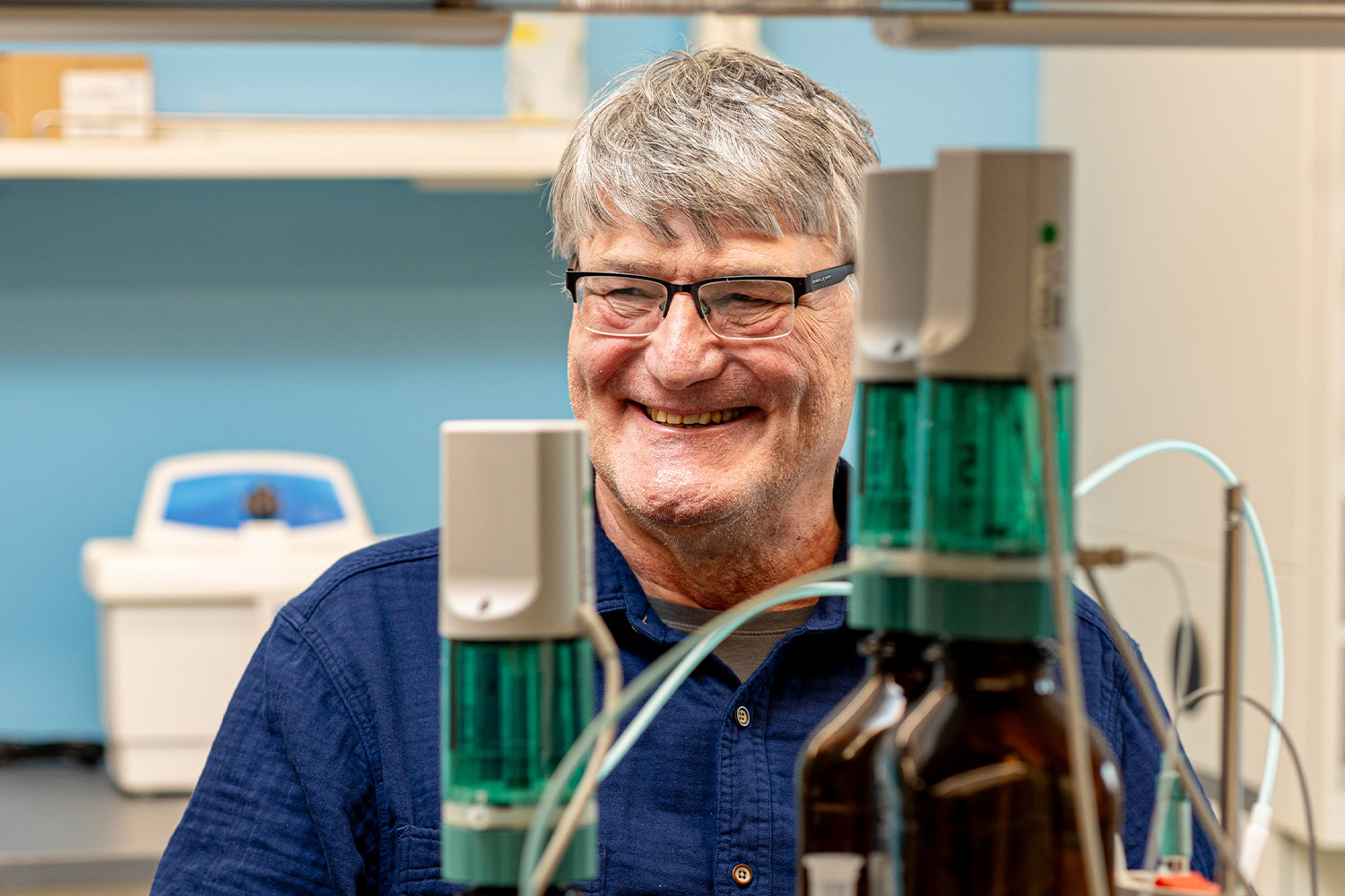 Tom Zawodzinski smiling while working in the lab