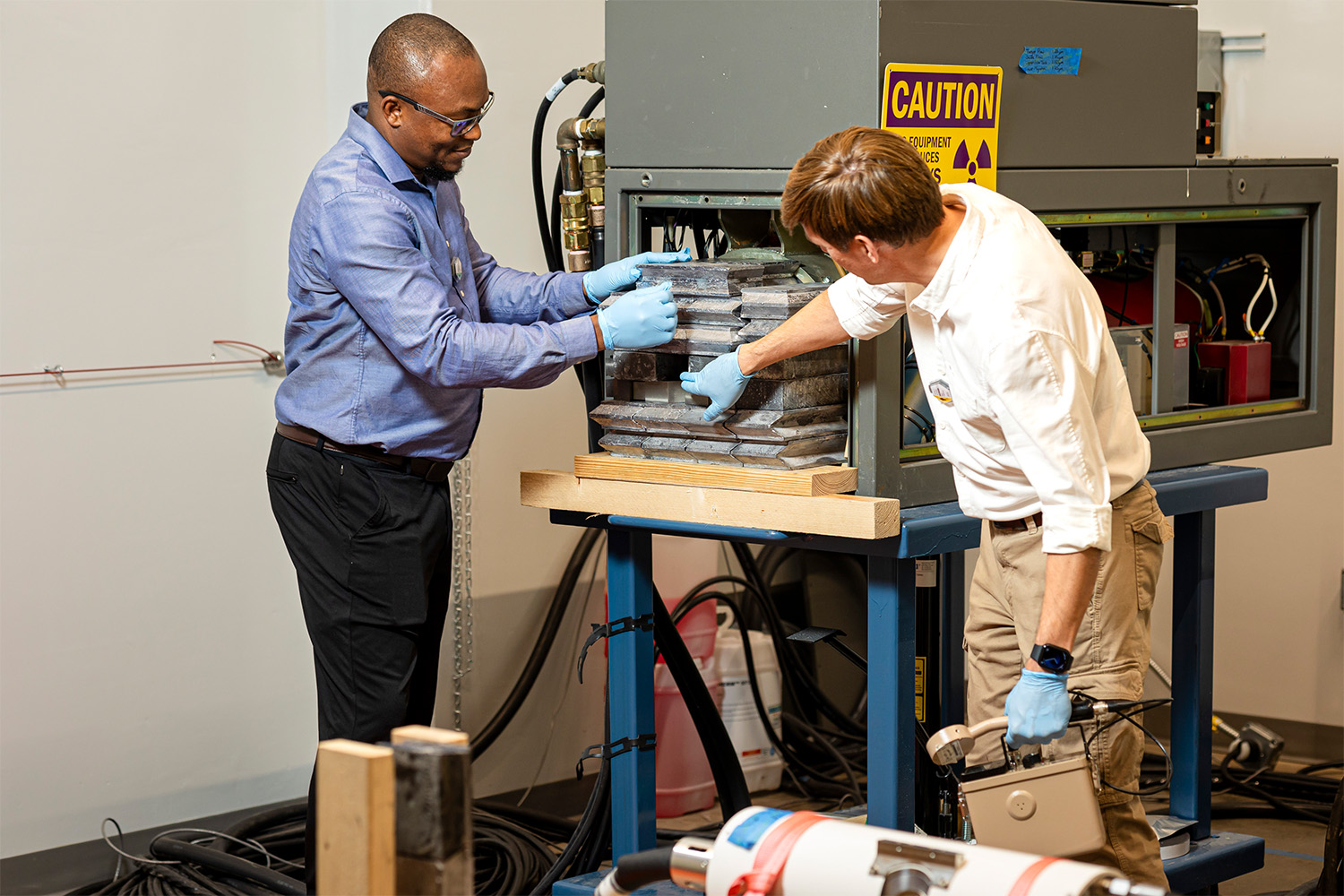 Jason Hayward and professor setting up the neutron source