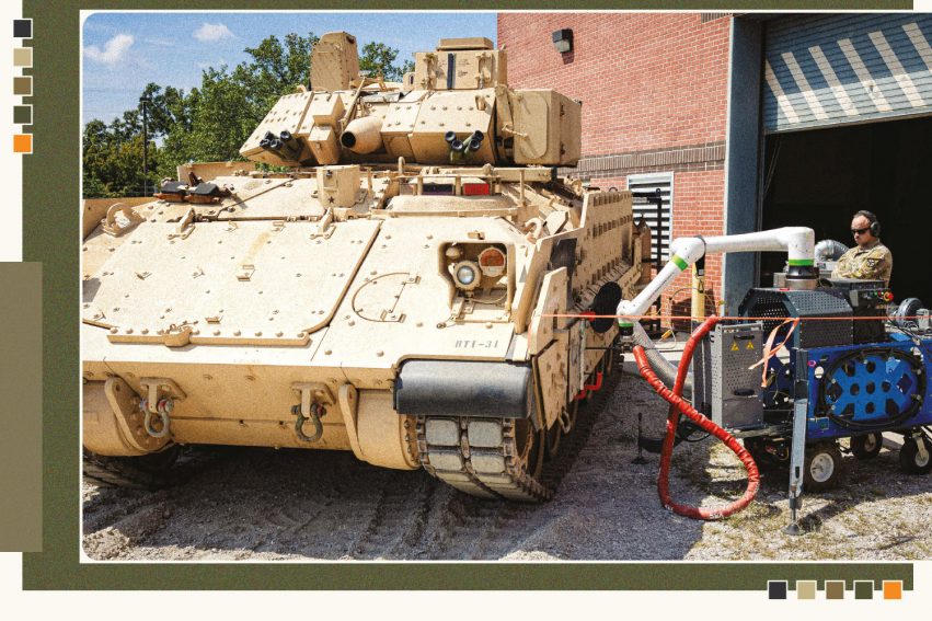 Military service member demonstrates field repairs on vehicle