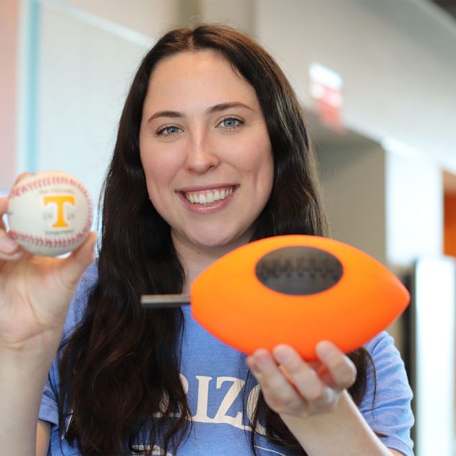 Cameron Castleberry holds the football and baseball that were put inside the hypersonics tunnel.