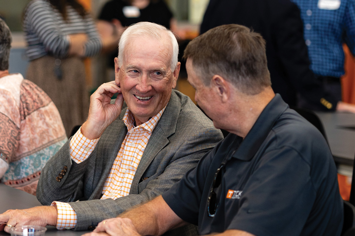 Two invited guests have a conversation prior to ceremony