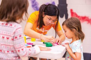 UT Student Works with Elementary School Student at Outreach Event