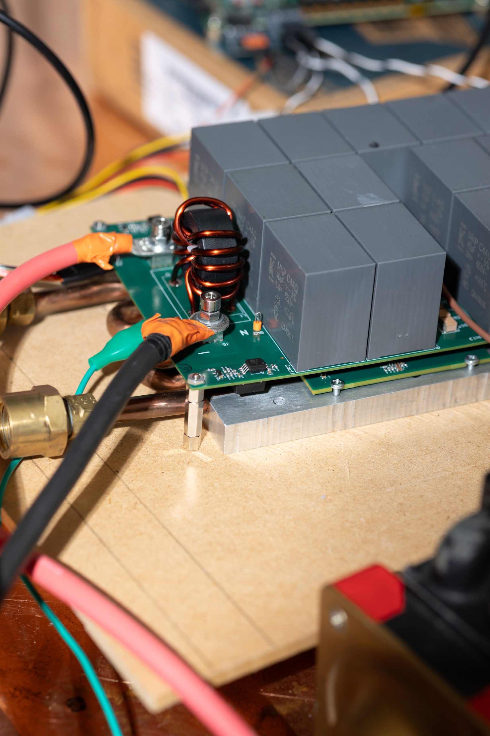 Small circuit board with series film capacitors sitting on top