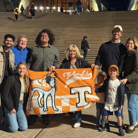 Deep Mistry, Anna Witsoe, Darrin Rhines, Connor Davis, Suzanne Sawicki, Ryan Welker, and his family holding a UT flag with Smokey on it.