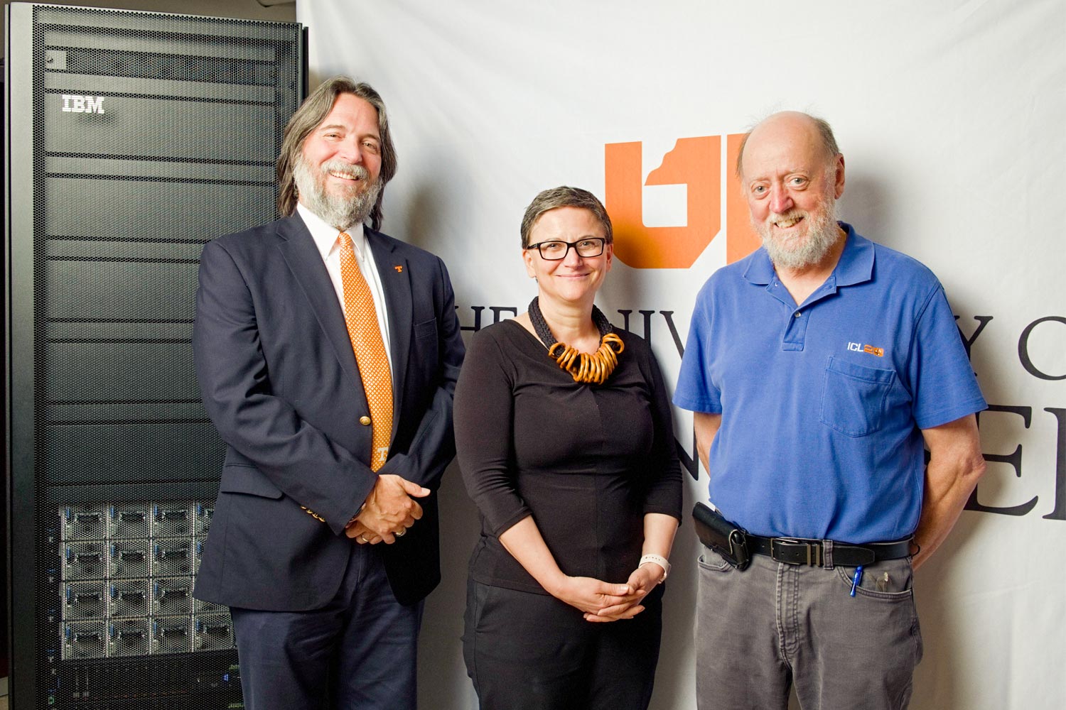 Peterson, Taufer, and Dongarra stand in front of IBM Supercomputer