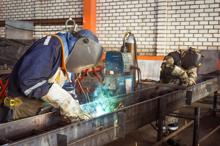 Two People Welding