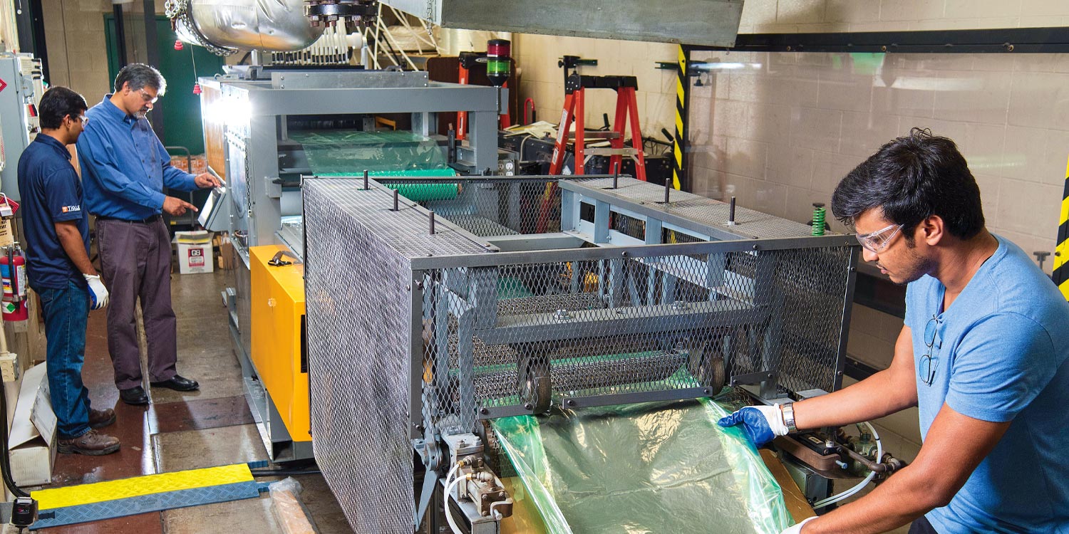 Uday Vaidya works with two grad students in a FCMF Lab