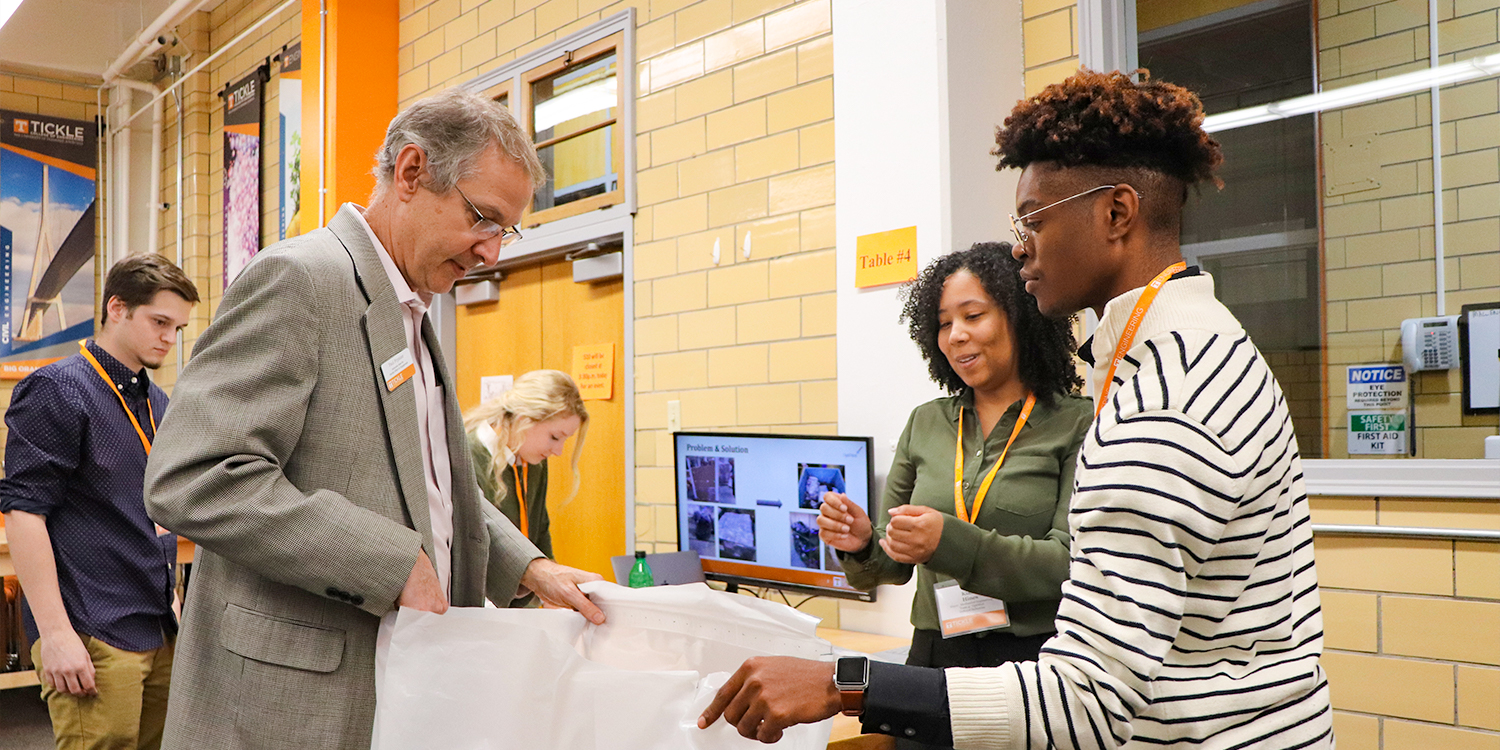 Frenando Blevins demonstrates his team's project to Paul Frymeir