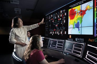 Yilu Liu works with students in Power Lab