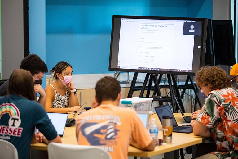 Students working with board in new classroom
