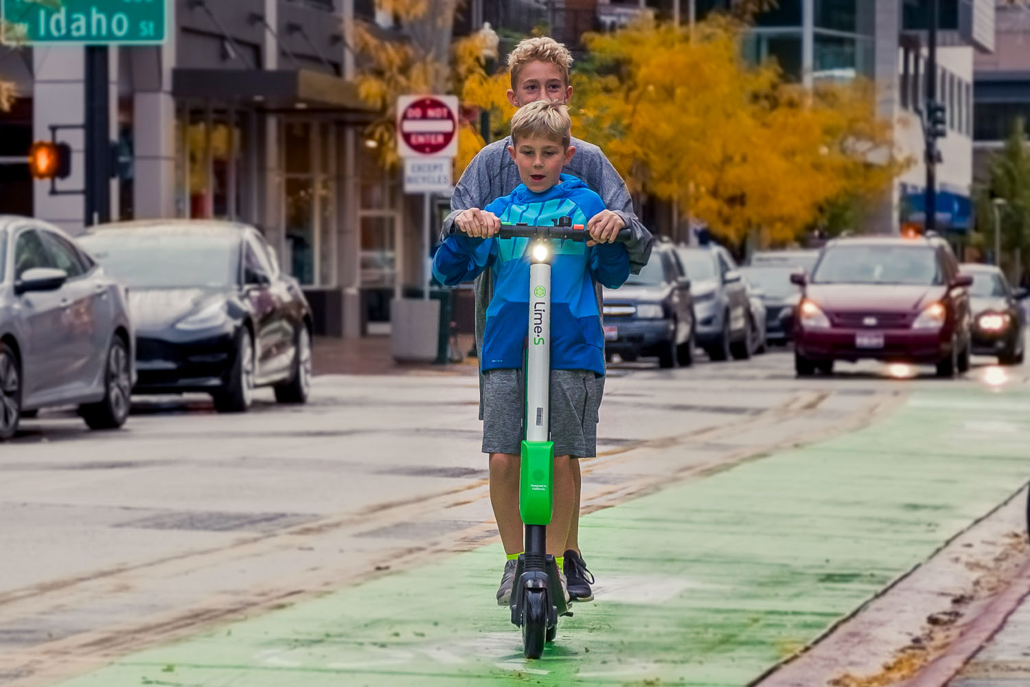 Two people riding E-Scooter on a Street