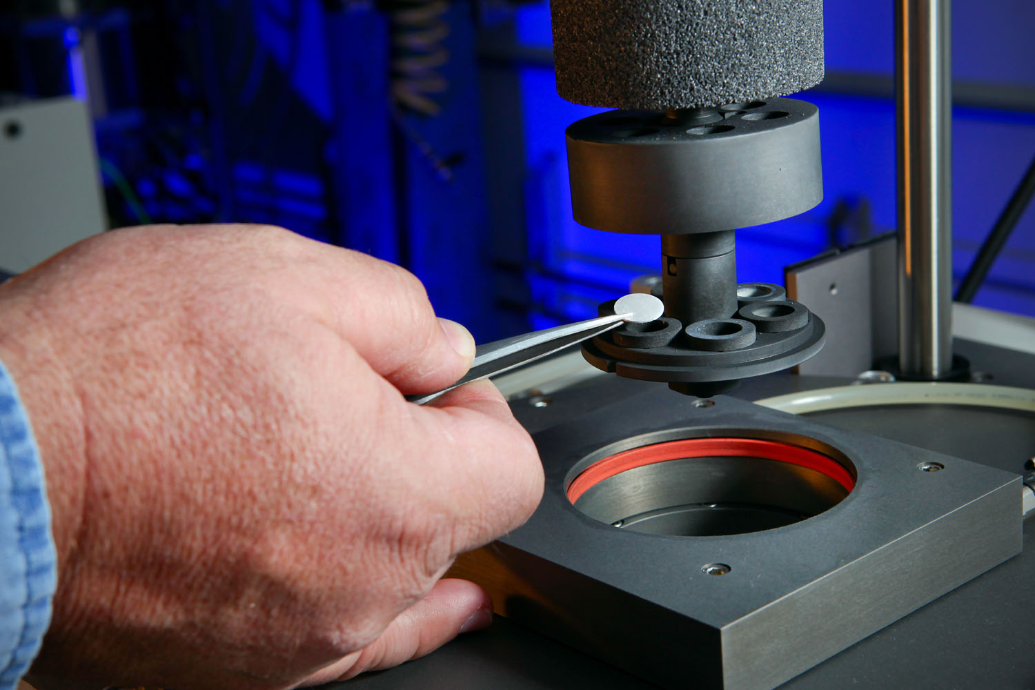 Man places item on microscope
