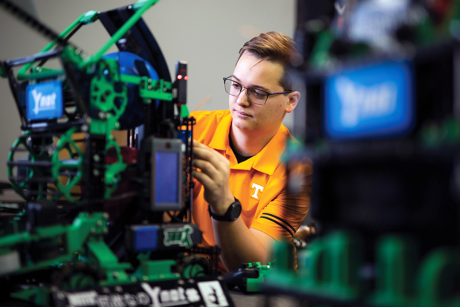 Grant Kobes works on the robot.