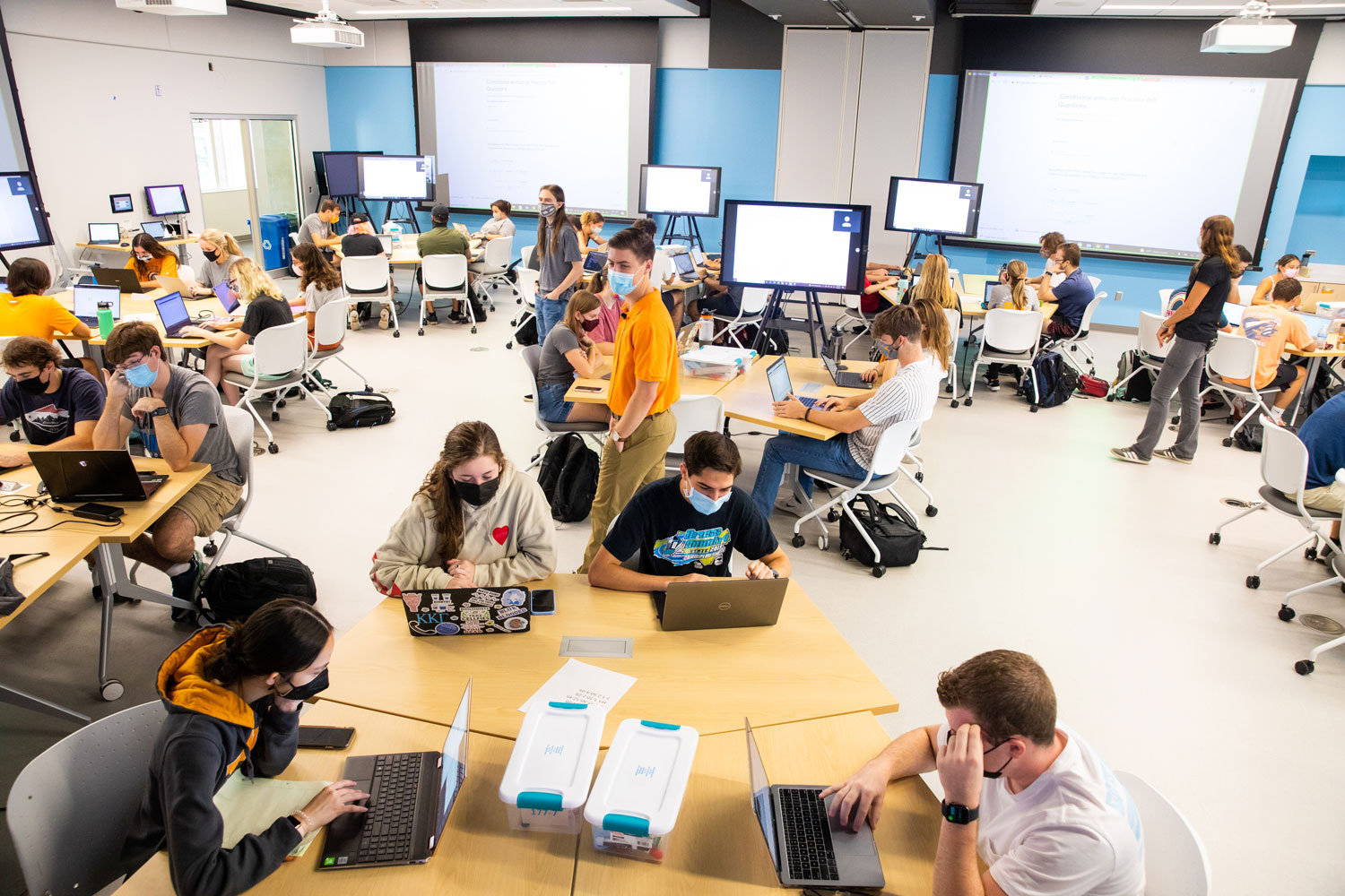 GTA works with students during class