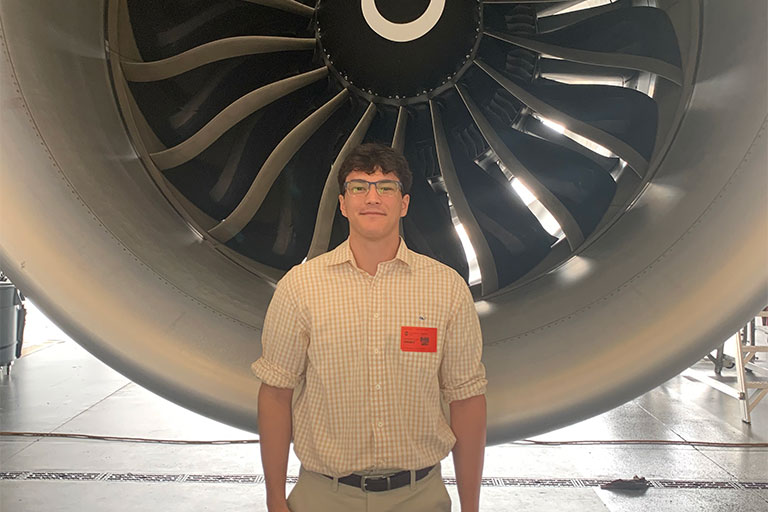 Chris in front of plane engine