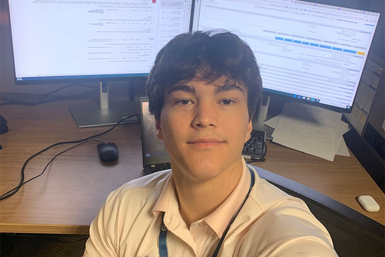 Chris in front of a computer