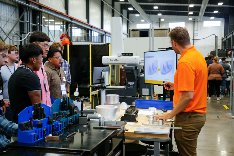 Students watching a presentation during manufacturing day
