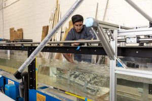 student running tests on the water turbidity equipment in a lab
