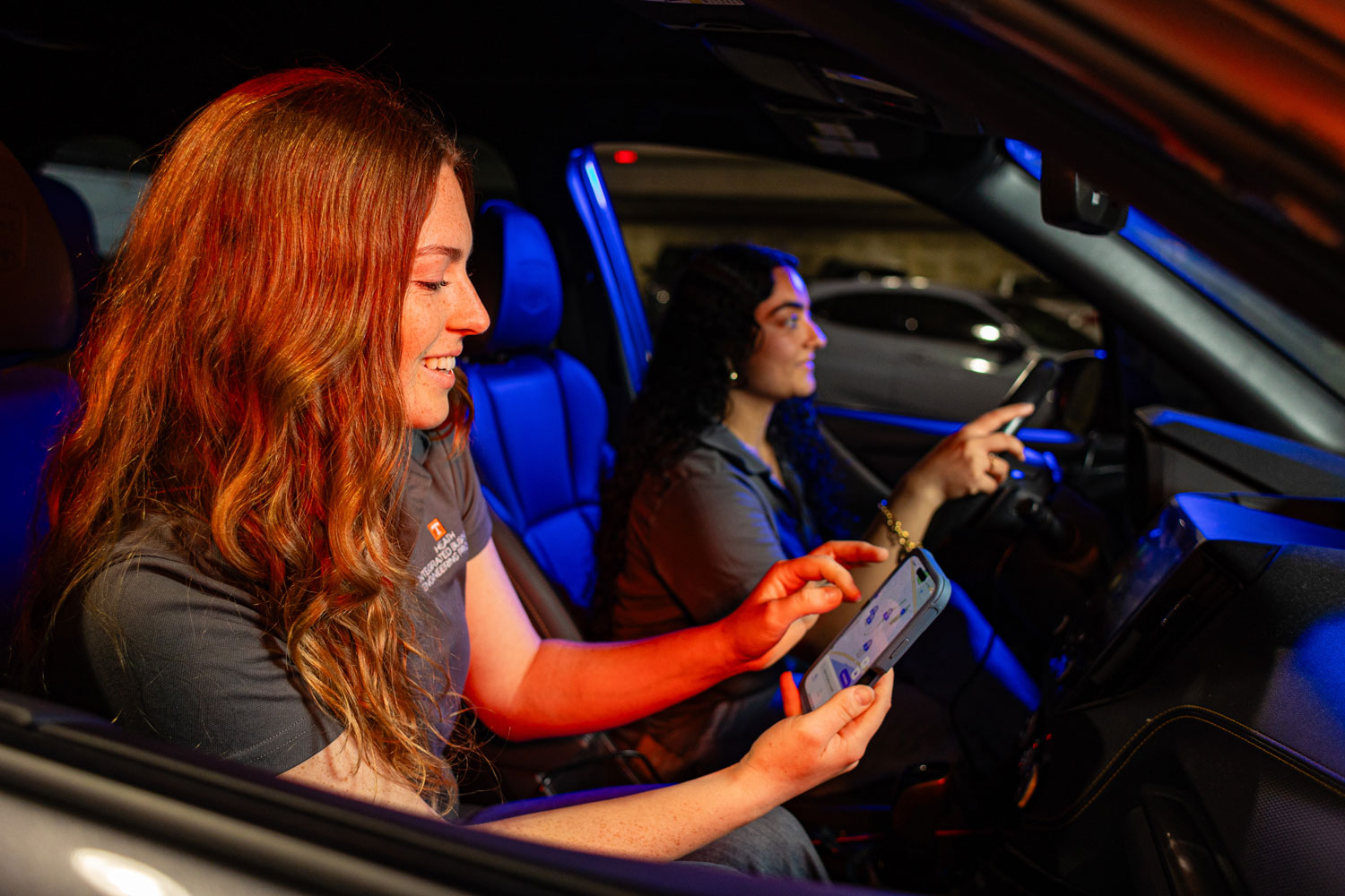 Students in car looking at parking app