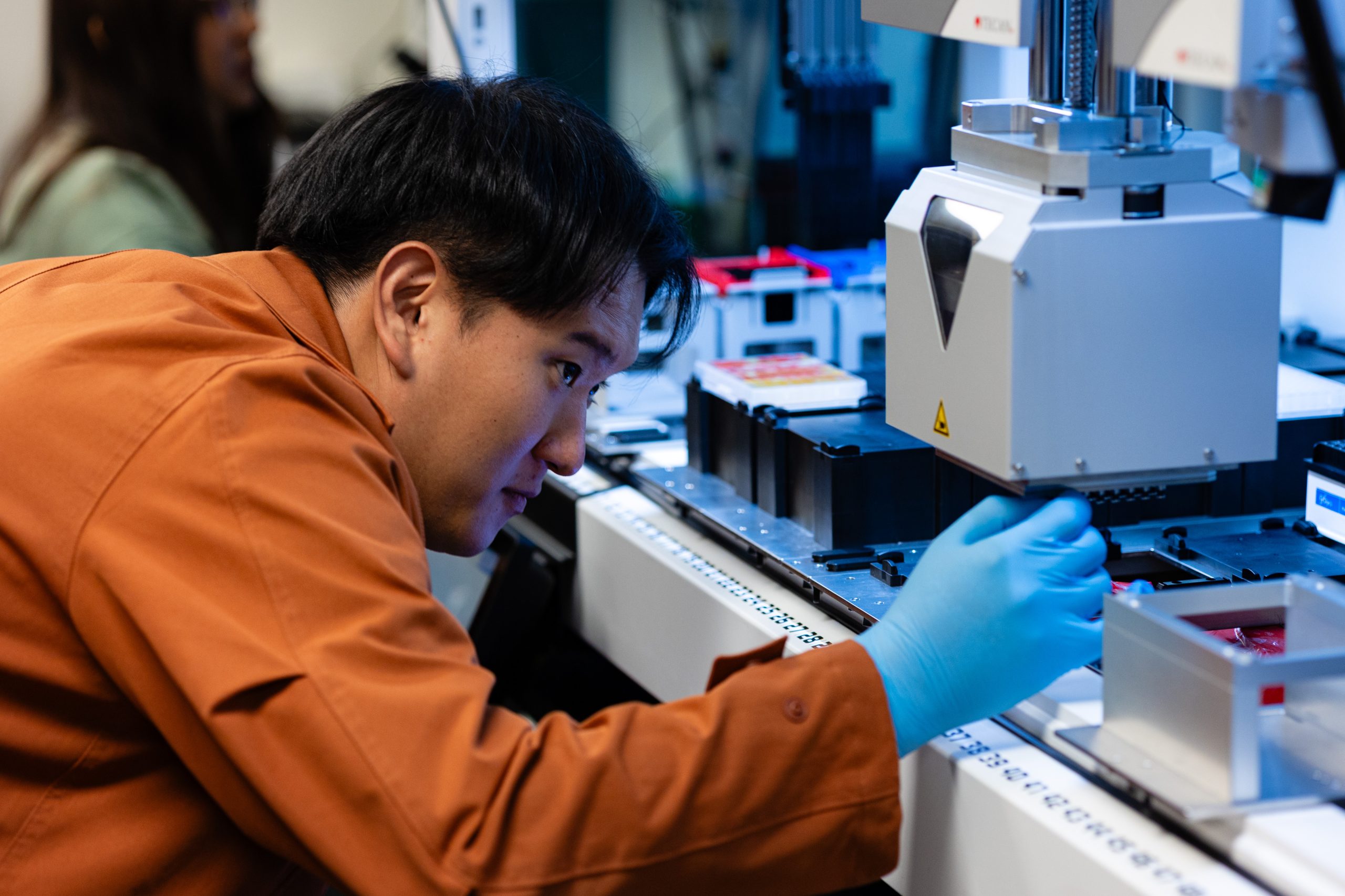 A student works with a machine in a lab