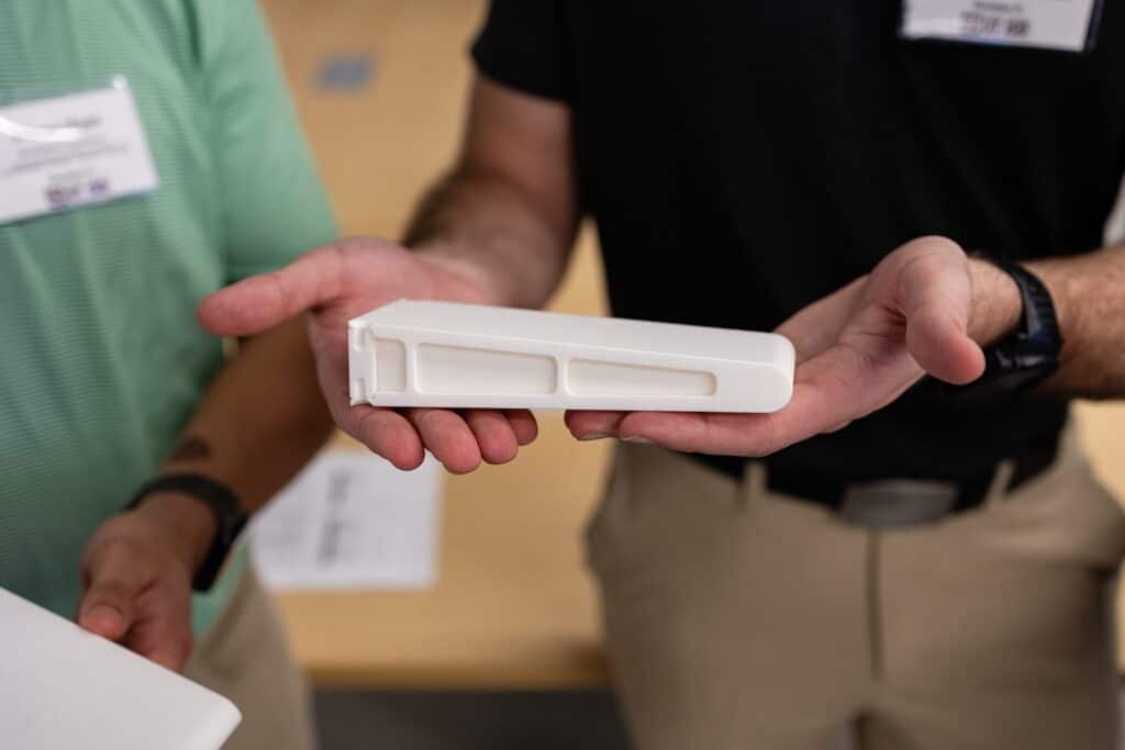 A close-up of a team member holding a project mechanism 